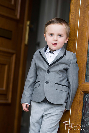 kid standing with his tongue out by a door