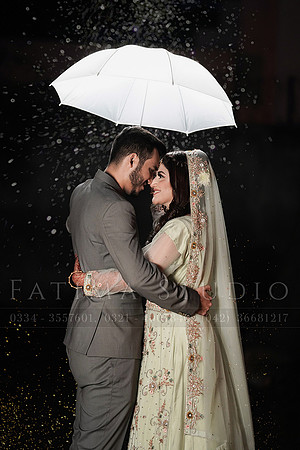 Couple holding an umbrella