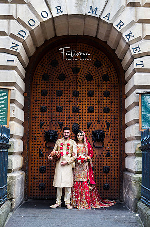 Pakistani bride & Groom standing by an Antique wooden door